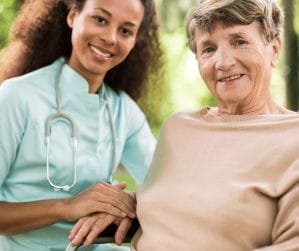 female doctor smiling with elderly woman